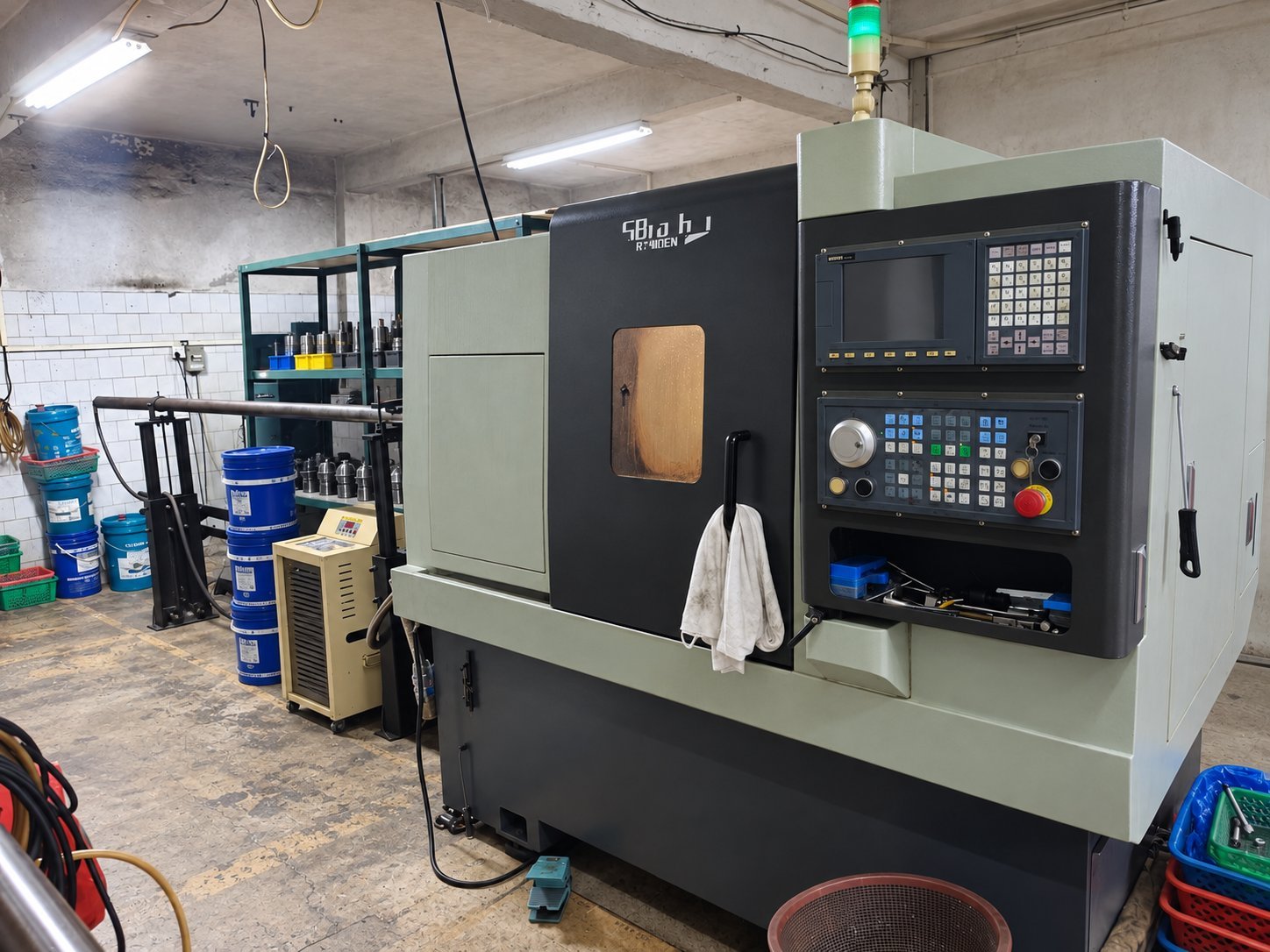 CNC lathe with a bar feeder on the workshop floor in Dongguan